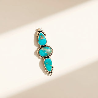 Turquoise stone ring on a beige background