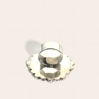 Silver ring on a beige background